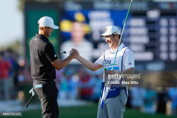 Ludvig Aberg of Sweden celebrates with his caddie after winning The RSM Classic on the Seaside Course at Sea Island Resort on November 19, 2023 in St...
