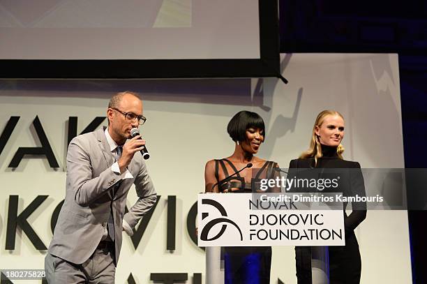 Auctioneer Andrew Boose and models Naomi Campbell and Anne V speak on stage at the Novak Djokovic Foundation New York dinner at Capitale on September...