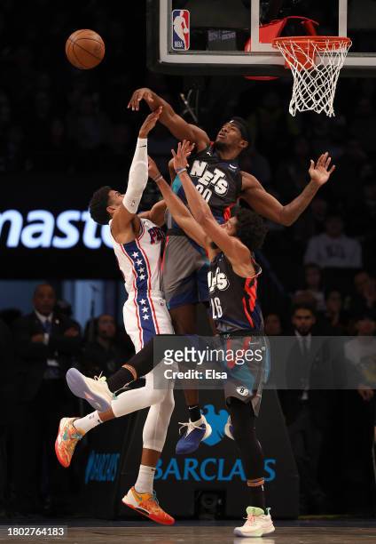 Day'Ron Sharpe of the Brooklyn Nets blocks a shot by Tobias Harris of the Philadelphia 76ers as Spencer Dinwiddie of the Brooklyn Nets defends in the...
