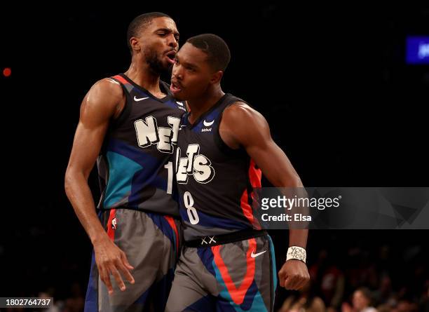 Mikal Bridges of the Brooklyn Nets celebrates with teammate Lonnie Walker IV of the Brooklyn Nets after Walker IV dunked in the first half against...