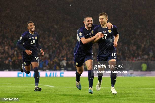 Stuart Armstrong of Scotland celebrates with teammate John McGinn after scoring the team's third goal during the UEFA EURO 2024 European qualifier...