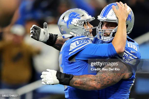Jared Goff and Taylor Decker of the Detroit Lions celebrate a touchdown during the fourth quarter against the Chicago Bears at Ford Field on November...