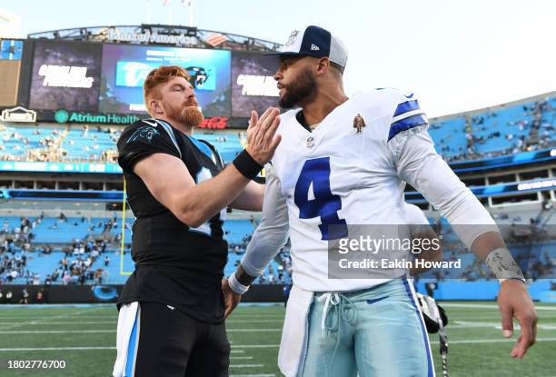 Andy Dalton of the Carolina Panthers and Dak Prescott of the Dallas Cowboys embrace after the game at Bank of America Stadium on November 19, 2023 in...
