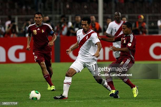 Carlos Augusto Lobaton Espejo of Peru competes for the ball with Yohandry Orozco of Venezuela during a match between Venezuela and Peru as part of...