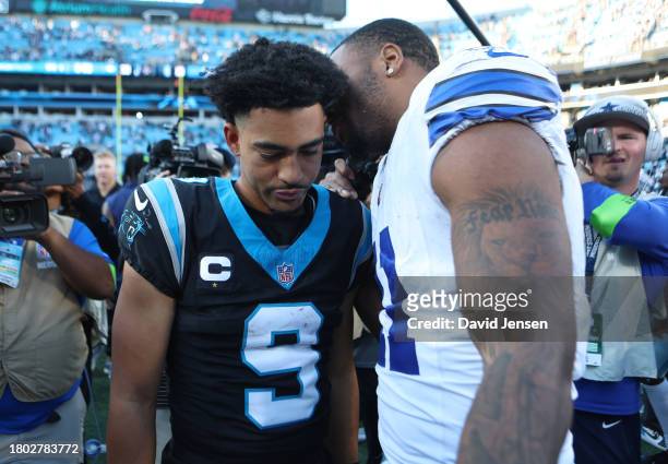 Bryce Young of the Carolina Panthers speaks with Micah Parsons of the Dallas Cowboys after the game at Bank of America Stadium on November 19, 2023...