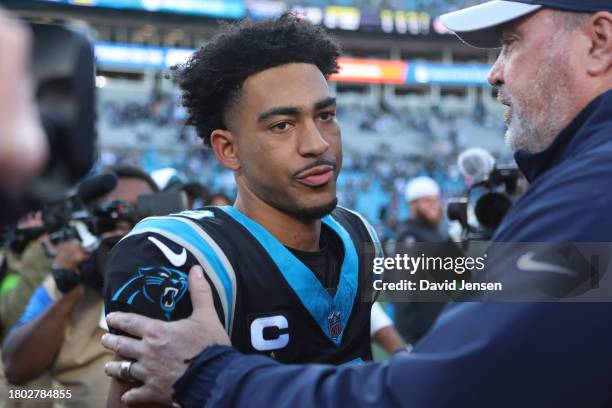 Bryce Young of the Carolina Panthers and head coach Mike McCarthy of the Dallas Cowboys embrace after the game at Bank of America Stadium on November...