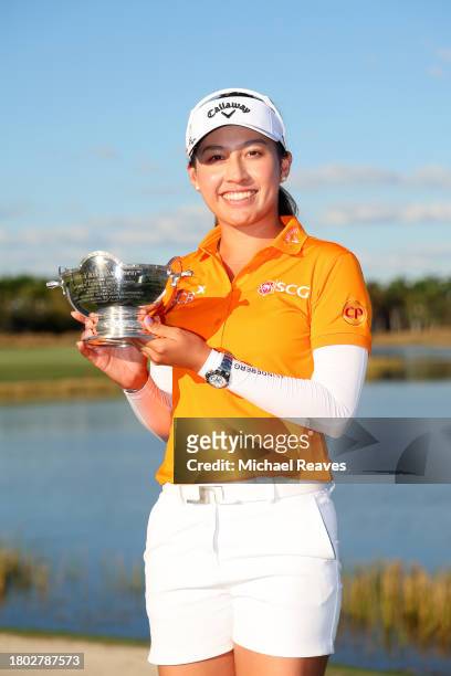 Atthaya Thitikul of Thailand celebrate with the Vare trophy after the CME Group Tour Championship at Tiburon Golf Club on November 19, 2023 in...