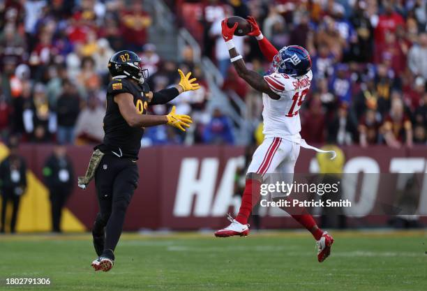 Isaiah Simmons of the New York Giants makes an interceptions and returns it for a touchdown during the fourth quarter in the game against the...