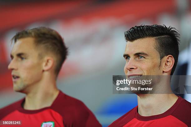 Wales player Gareth Bale chats with team mate Jack Collison before the FIFA 2014 World Cup Qualifier Group A match between Wales and Serbia at...