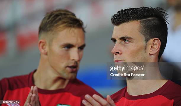 Wales player Gareth Bale chats with team mate Jack Collison before the FIFA 2014 World Cup Qualifier Group A match between Wales and Serbia at...