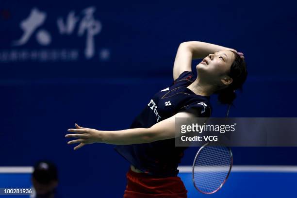 Minatsu Mitani of Japan competes in the women's singles match against Nichaon Jindapon of Thailand on day 2 of the 2013 China Badminton Masters at...