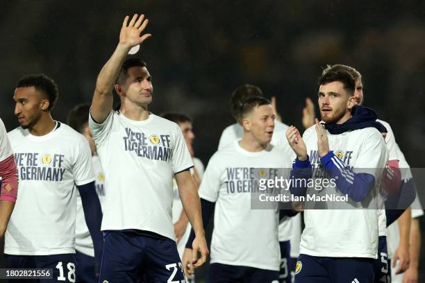 Kenny McLean and Andrew Robertson of Scotland applaud the fans wearing 'we're off to Germany' shirts after their qualification for UEFA EURO 2024...