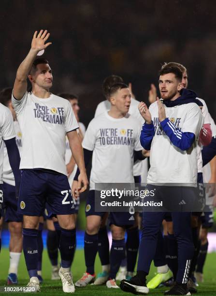 Kenny McLean and Andrew Robertson of Scotland applaud the fans wearing 'we're off to Germany' shirts after their qualification for UEFA EURO 2024...