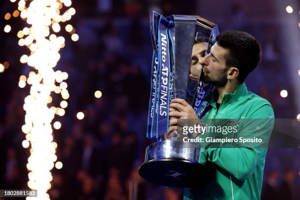 Novak Djokovic of Serbia kisses the Nitto ATP Finals trophy after victory against Jannik Sinner of Italy in the Men's Singles Finals between Jannik...