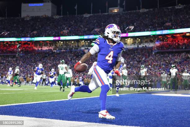 James Cook of the Buffalo Bills scores a touchdown in the second quarter against the New York Jets at Highmark Stadium on November 19, 2023 in...