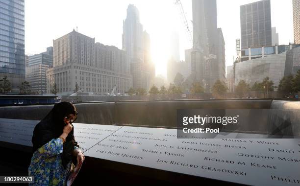Showkatara Sharif, of Chantilly, Virginia, stands next to the engraving of her daughter's name, Shakila Yasmin, at the edge of the North Pool at the...