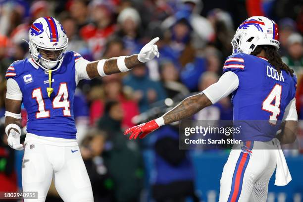 Stefon Diggs and James Cook of the Buffalo Bills celebrate after Cook scored a touchdown in the second quarter against the New York Jets at Highmark...