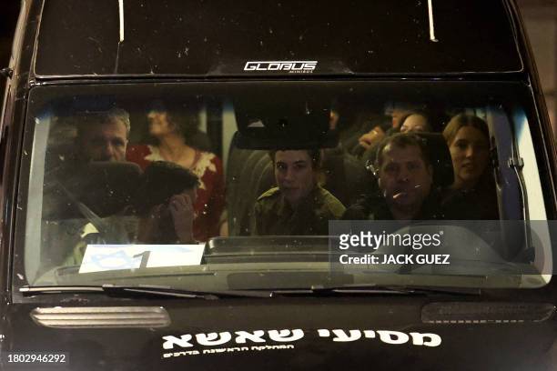 Vehicle carrying Israeli hostages released by Hamas from the Gaza Strip arrives at the Sheba Medical Center in Ramat Gan, early on November 26, 2023....
