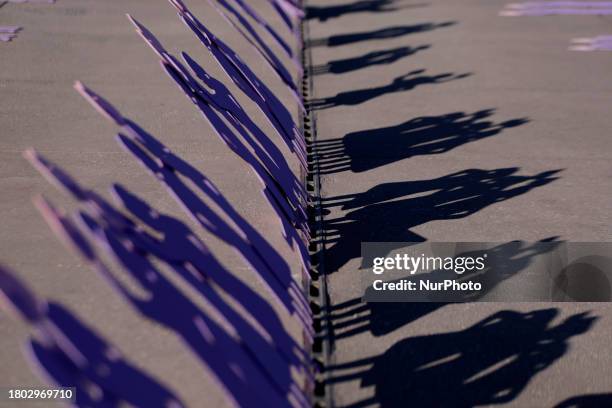 Mothers of missing daughters, victims of feminicide and sexist violence, are demonstrating with silhouettes of wooden women in front of the National...