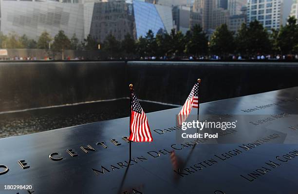 Flags stand in a name on the 9/11 Memorial during ceremonies for the twelfth anniversary of the terrorist attacks on lower Manhattan at the World...