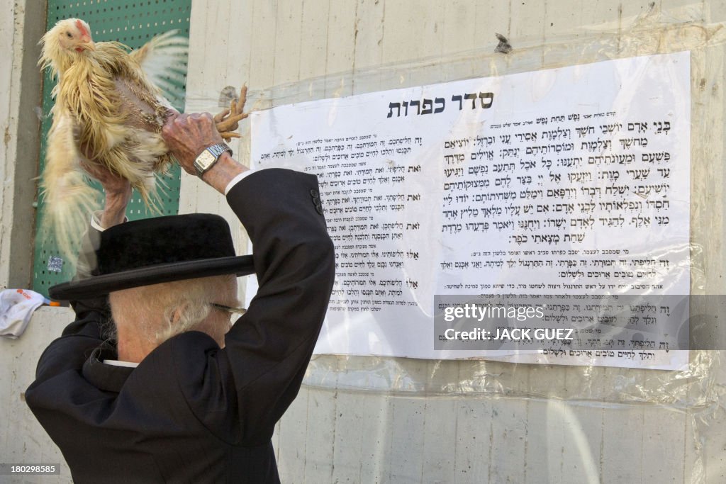 Kaparot Ritual An Ultra-orthodox Jewish man swings a chicken above his head during ...