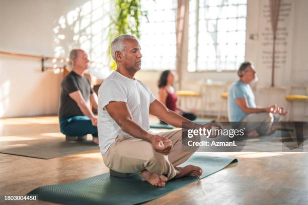 a diverse yoga class for health and wellness - zen like stock pictures, royalty-free photos & images