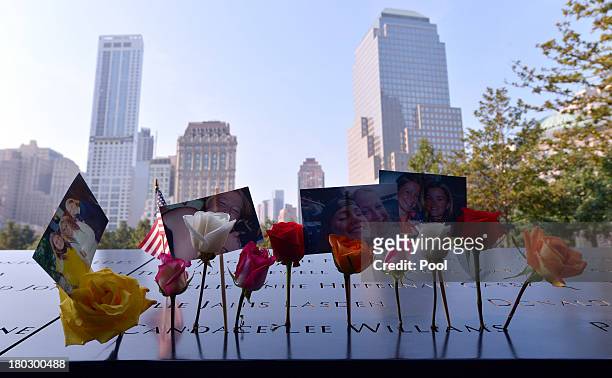 Flowers and pictures left along the North Pool at the 9/11 Memorial during ceremonies for the twelfth anniversary of the terrorist attacks on lower...