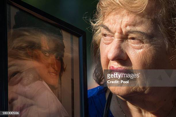 Ester DiNardo, mother of Marisa DiNardo, clutches her image while attending the 9/11 Memorial ceremonies marking the 12th anniversary of the 9/11...