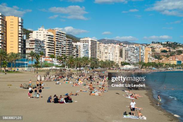 groups of people enjoying malagueta beach, málaga on a sunny october saturday - malaga beach bildbanksfoton och bilder