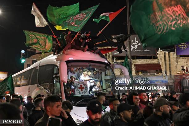 The crowd surrounds a Red Cross bus carrying Palestinian prisoners released from Israeli jails in exchange for hostages released by Hamas from the...