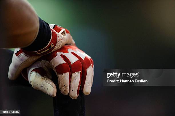 Wilkin Ramirez of the Minnesota Twins rests his Franklin gloves on his bat during the game against the Kansas City Royals on August 27, 2013 at...