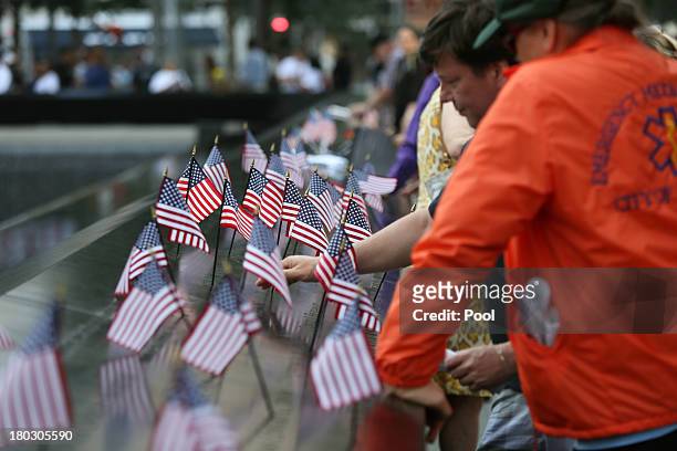 Rows of American flags are placed on the South Pool of the 9/11 Memorial during ceremonies for the twelfth anniversary of the terrorist attacks on...