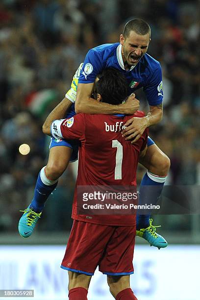 Leonardo Bonucci and Gianluigi Buffon of Italy celebrate victory at the end of the FIFA 2014 World Cup Qualifier group B match between Italy and...