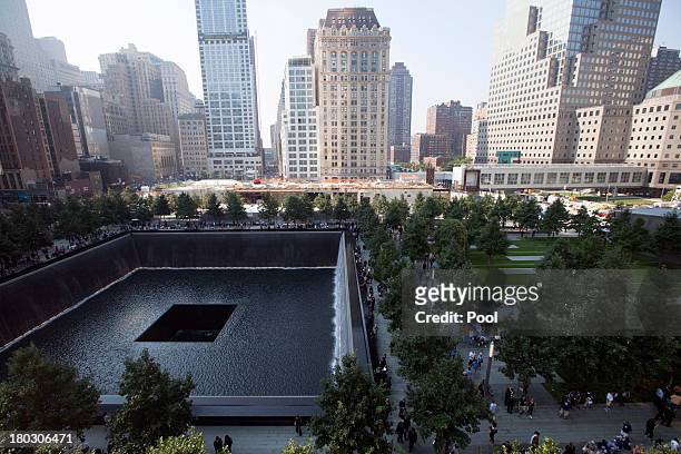 Victims family members view names along the south reflecting pool at the 9/11 Memorial during ceremonies for the 12th anniversary of the terrorist...
