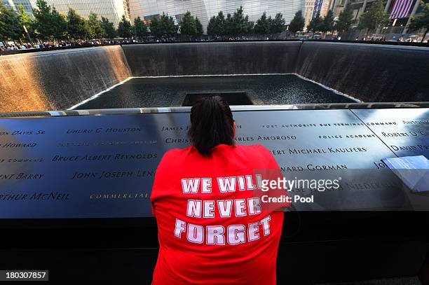 Friends and family members gather at the 9/11 Memorial during ceremonies marking the 12th anniversary of the 9/11 attacks on the World Trade Center...