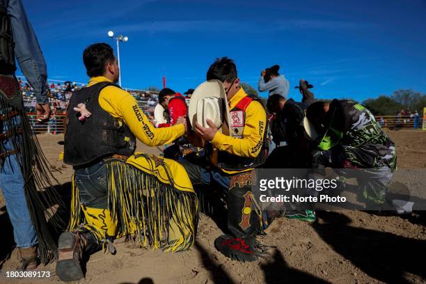 Competitors participate in a prayer prior to the third competition date of the Sonora Rodeo circuit on November 19, 2023 in Moctezuma, Mexico.