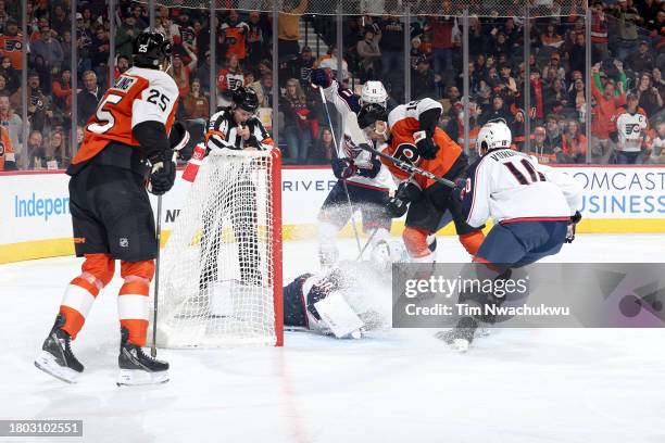 Ryan Poehling and Garnet Hathaway of the Philadelphia Flyers react after a goal by Poehling past Spencer Martin of the Columbus Blue Jackets during...