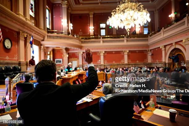 Senator Jeff Bridges raises his hand for a yes vote on SB23B-001 on the floor of the Senate chambers at the Colorado State Capitol on November 19,...