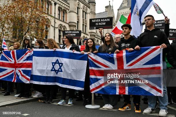 Protesters wave Israeli and Union Jack flags, during a demonstration in central London on November 26, 2023 to protest against antisemitism.