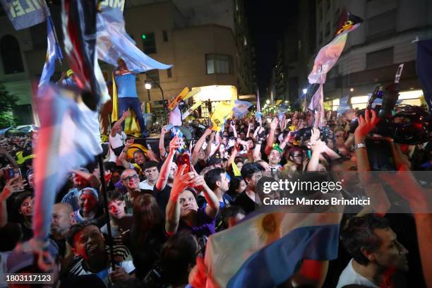 Supporters of presidential candidate for La Libertad Avanza Javier Milei celebrate after the polls closed in the presidential runoff on November 19,...