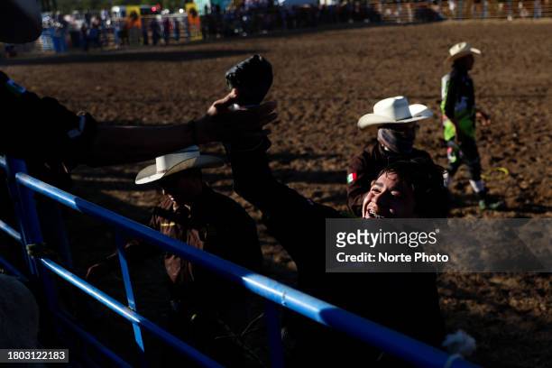 Gama Salazar celebrates his ride in the bull riding event during the third competition date of the Sonora Rodeo circuit on November 19, 2023 in...
