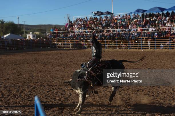 Gama Salazar competes in the bull riding event during the third competition date of the Sonora Rodeo circuit on November 19, 2023 in Moctezuma,...