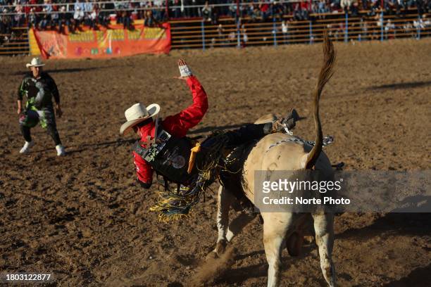 Bull rider Javier Ruiz competes in the bull riding event during the third competition date of the Sonora Rodeo circuit on November 19, 2023 in...