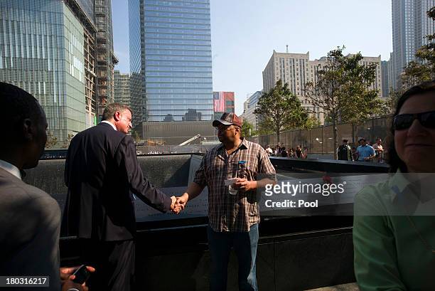 Democratic candidate for mayor Bill de Blasio speaks to a visitor at the 9/11 Memorial during ceremonies for the 12th anniversary of the terrorist...