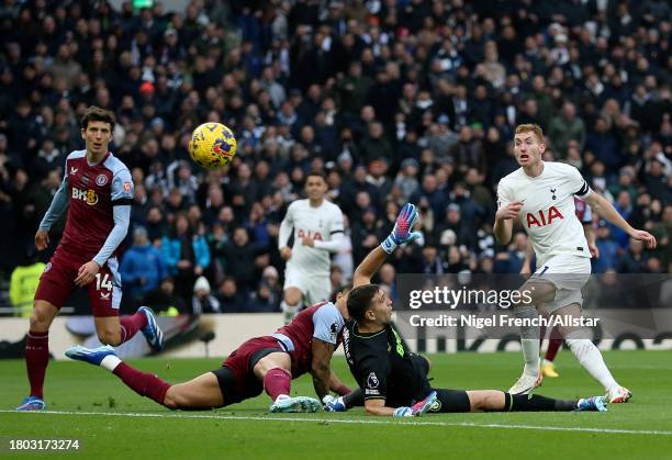 Dejan Kulusevski of Tottenham Hotspur shoots over Emiliano Martinez, goalkeeper of Aston Villa during the Premier League match between Tottenham...