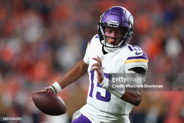 Quarterback Joshua Dobbs of the Minnesota Vikings scrambles with the football during the first quarter of the NFL game against the Denver Broncos at...