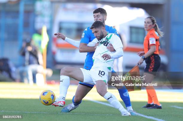 Liberato Giampaolo Cacace of Empoli FC battles for the ball with Domenico Berardi of US Sassuolo during the Serie A TIM match between Empoli FC and...