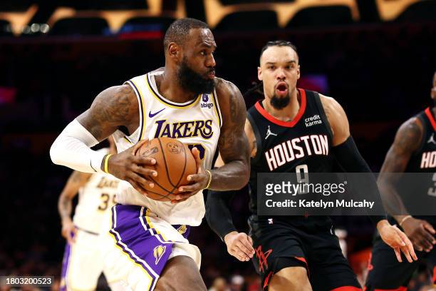 LeBron James of the Los Angeles Lakers drives to the basket against Dillon Brooks of the Houston Rockets during the first quarter at Crypto.com Arena...