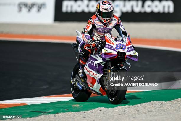 Ducati Spanish rider Jorge Martin rides on the gravel following Honda Spanish rider Marc Marquez's fall during the MotoGP Valencia Grand Prix at the...