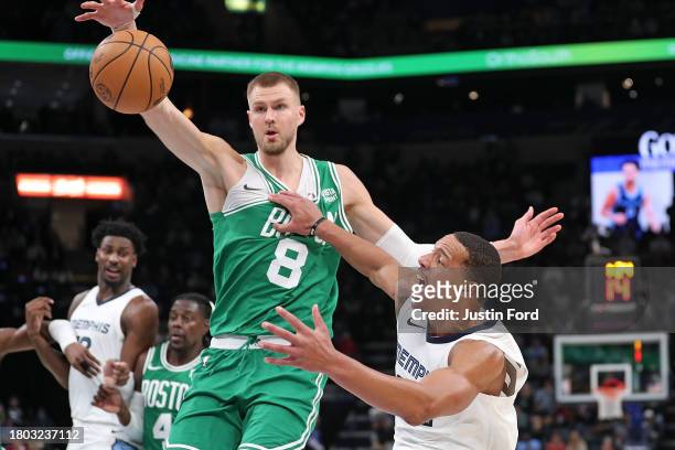Desmond Bane of the Memphis Grizzlies loses control of the ball during the second half against Kristaps Porzingis of the Boston Celtics at FedExForum...